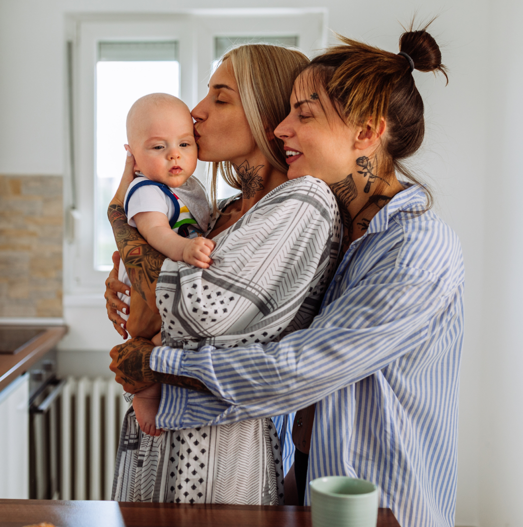 Mothers and child holding each other